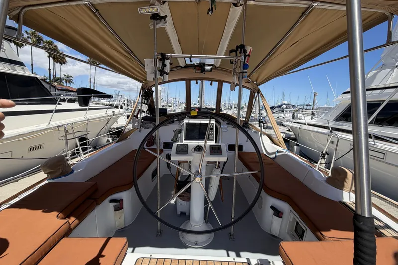 Slide: The Image of Cockpit view of a 2010 Beneteau Oceanis 37 sailboat docked at a marina. - 21