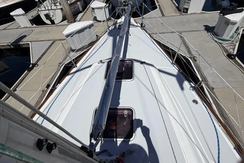 Slide: The Image of 2010 Beneteau Oceanis 37 sailboat docked, showcasing deck and rigging details. - 3