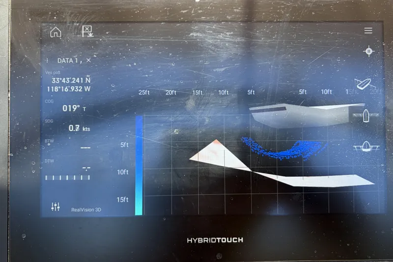 Slide: The Image of Navigation display on a 2010 Beneteau Oceanis 37 sailboat, showing coordinates and depth data. - 30