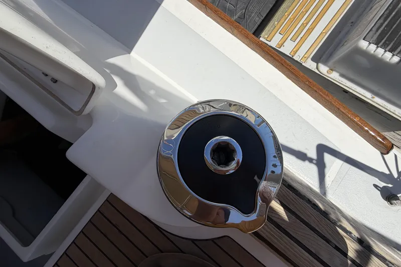 Slide: The Image of Winch on 2010 Beneteau Oceanis 37 sailboat deck, featuring wood and metal details. - 32