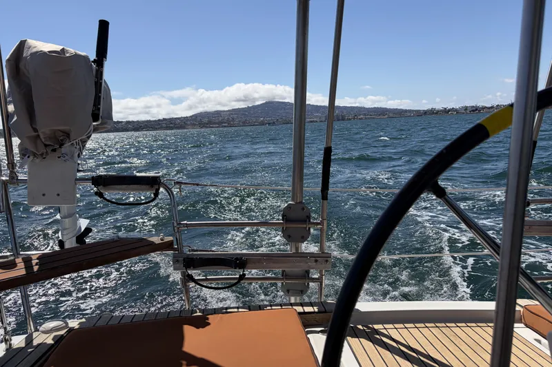 Slide: The Image of Beneteau Oceanis 37 sailing on open water, 2010 model, scenic coastal view. - 33