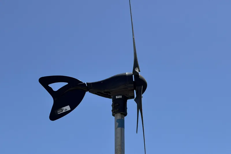 Slide: The Image of Wind turbine on a Beneteau Oceanis 37 sailboat, 2010 model, against clear blue sky. - 34