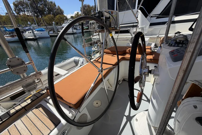 Slide: The Image of Cockpit of 2010 Beneteau Oceanis 37 sailboat with dual steering wheels and cushioned seating. - 35