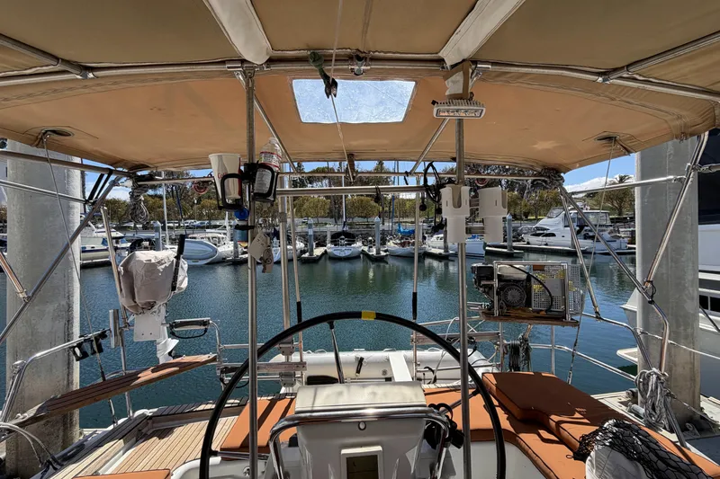 Slide: The Image of Cockpit view of a 2010 Beneteau Oceanis 37 sailboat docked at a marina. - 38