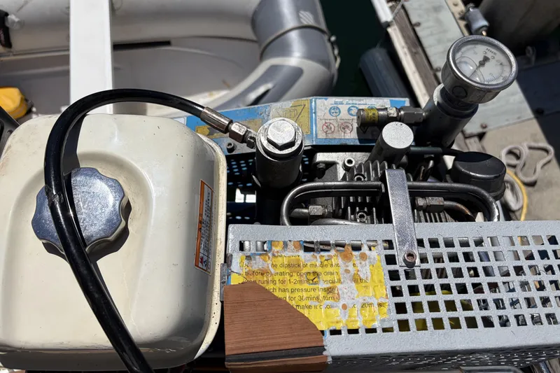 Slide: The Image of Close-up of a Beneteau Oceanis 37 engine component, featuring gauges and hoses, 2010 model. - 44