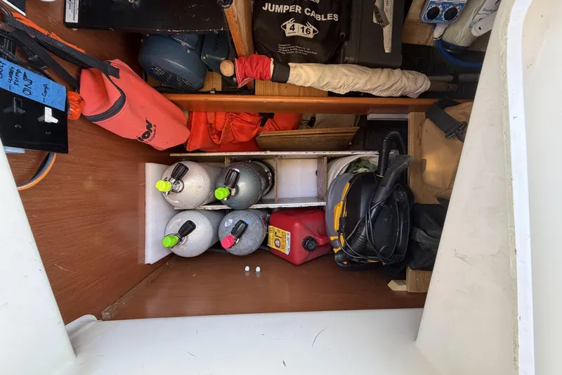 Slide: The Image of Storage compartment on a 2010 Beneteau Oceanis 37 sailboat with various equipment and supplies. - 45