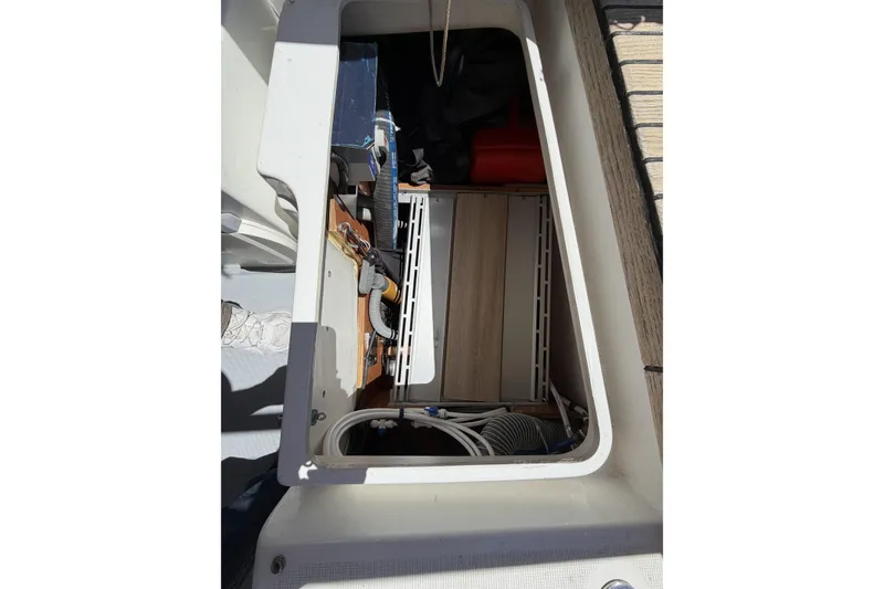 Slide: The Image of Storage compartment of a 2010 Beneteau Oceanis 37 sailboat, showing interior equipment and cables. - 46