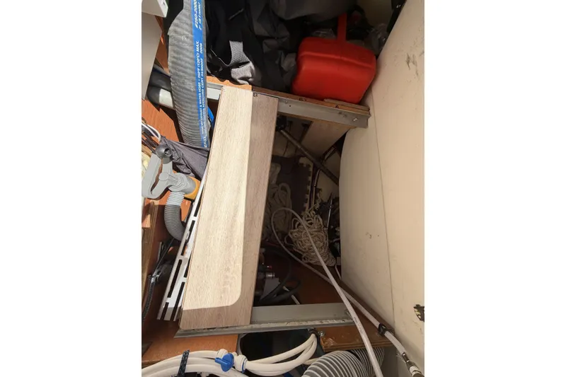 Slide: The Image of Interior storage area of a 2010 Beneteau Oceanis 37 sailboat, featuring ropes and equipment. - 47