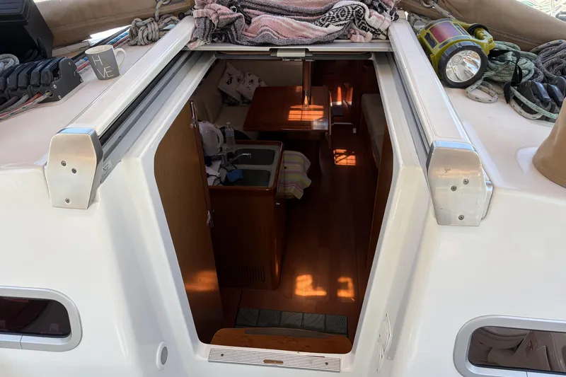 Slide: The Image of Interior view of 2010 Beneteau Oceanis 37 sailboat, showing cabin entrance and deck details. - 49