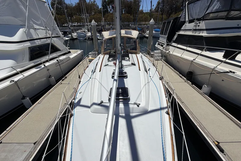 Slide: The Image of 2010 Beneteau Oceanis 37 sailboat docked between yachts in a marina. - 5