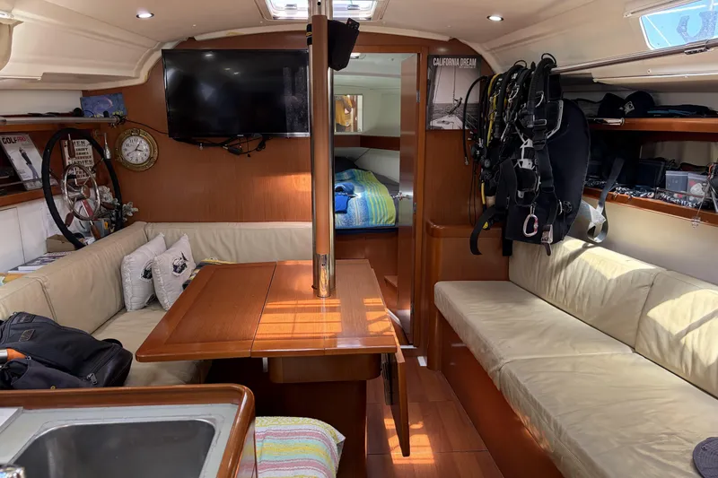 Slide: The Image of Interior of a 2010 Beneteau Oceanis 37 sailboat with cozy seating and nautical decor. - 51