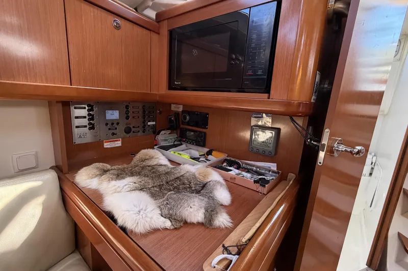 Slide: The Image of Interior of 2010 Beneteau Oceanis 37 yacht with navigation equipment and wooden cabinetry. - 55