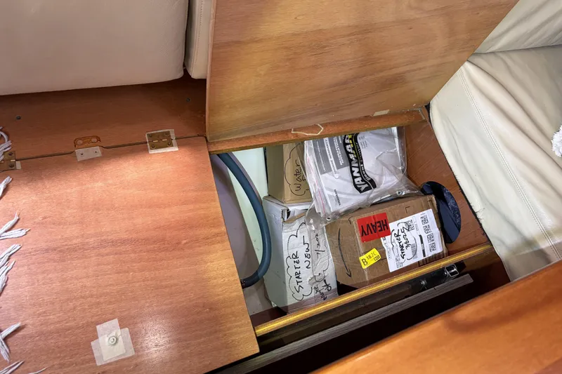 Slide: The Image of Storage compartment in a 2010 Beneteau Oceanis 37 yacht with labeled boxes and packages. - 56