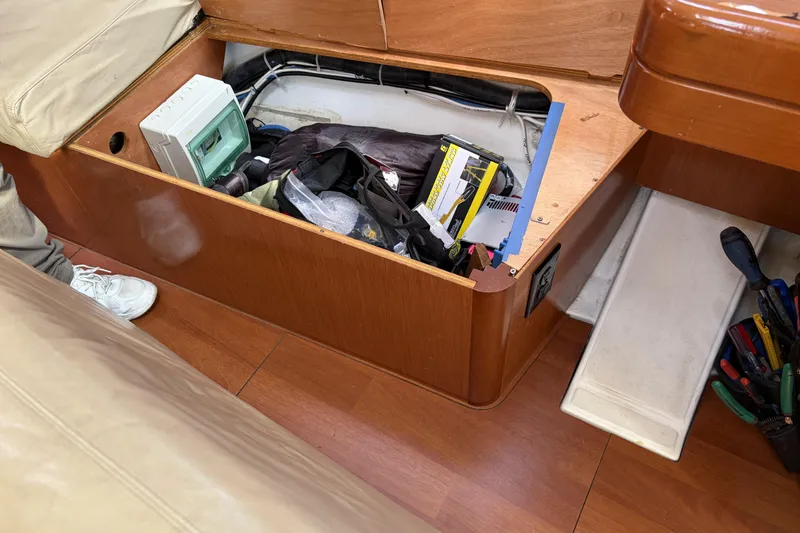 Slide: The Image of Storage compartment on a 2010 Beneteau Oceanis 37 sailboat with tools and equipment. - 58