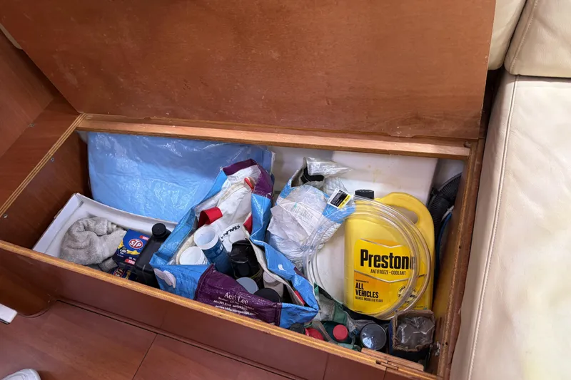 Slide: The Image of Storage compartment on a 2010 Beneteau Oceanis 37 with maintenance supplies and coolant. - 59