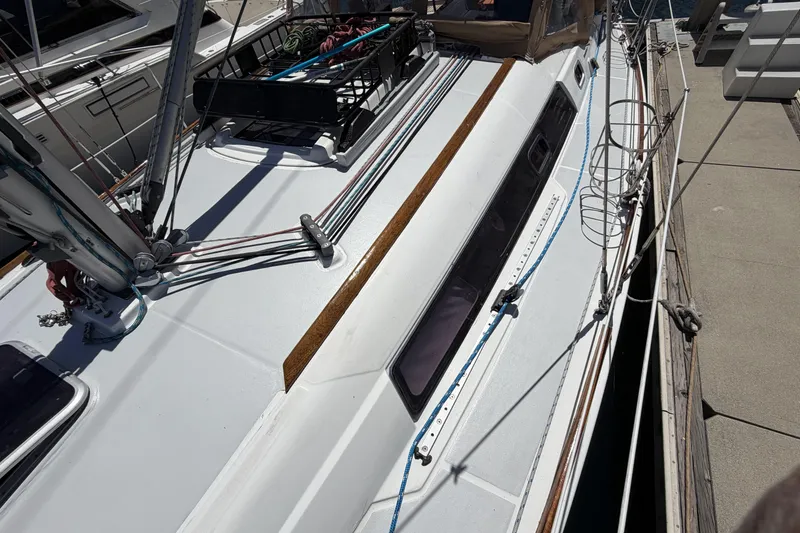Slide: The Image of Beneteau Oceanis 37 sailboat, 2010 model, docked with visible deck and rigging. - 6