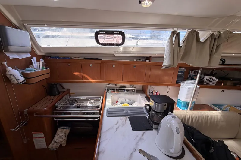 Slide: The Image of Interior of 2010 Beneteau Oceanis 37 yacht kitchen with stove, sink, and appliances. - 60