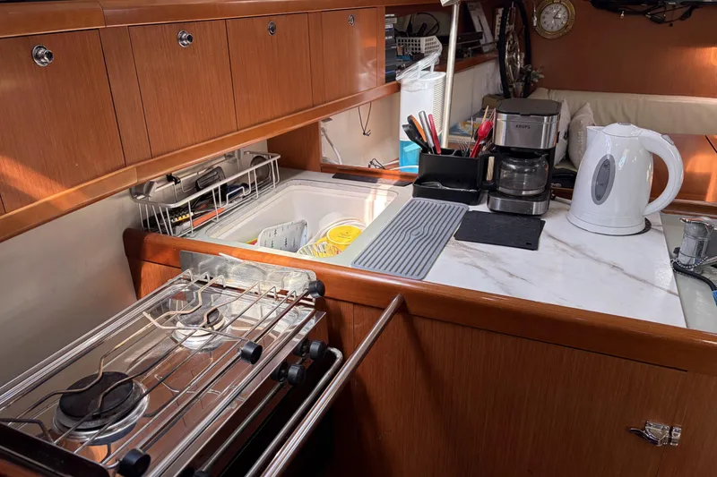 Slide: The Image of Galley kitchen in 2010 Beneteau Oceanis 37 yacht with stove, sink, and appliances. - 62