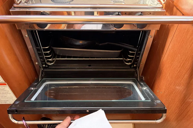 Slide: The Image of Open oven inside a 2010 Beneteau Oceanis 37 yacht kitchen. - 65
