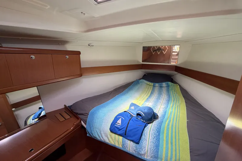 Slide: The Image of Cozy cabin interior of 2010 Beneteau Oceanis 37 sailboat with bed and storage. - 69