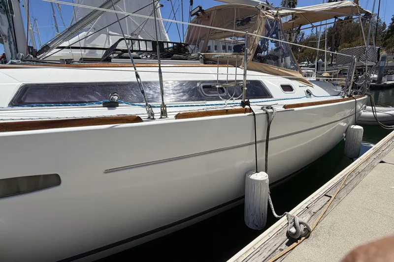 Slide: The Image of 2010 Beneteau Oceanis 37 sailboat docked at marina, side view. - 7