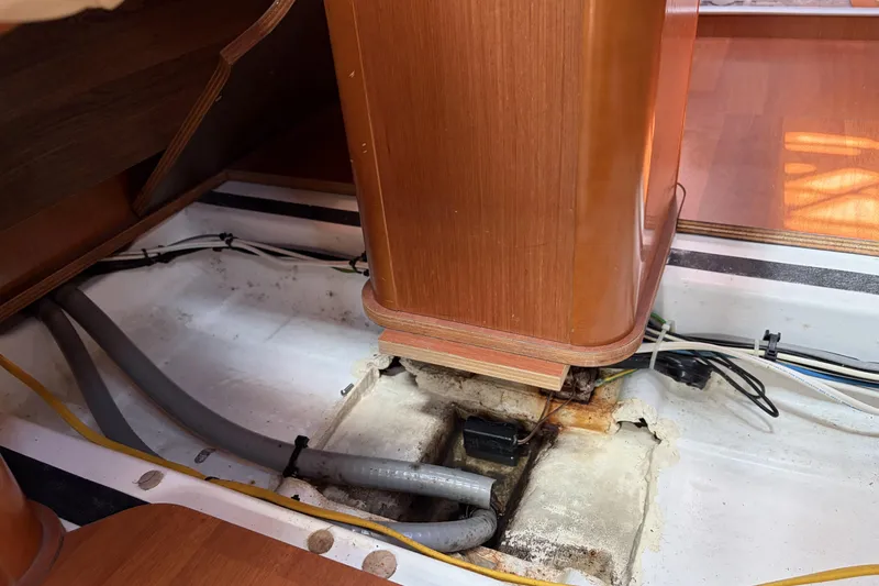 Slide: The Image of Interior view of a 2010 Beneteau Oceanis 37 sailboat, showing exposed wiring and pipes. - 76