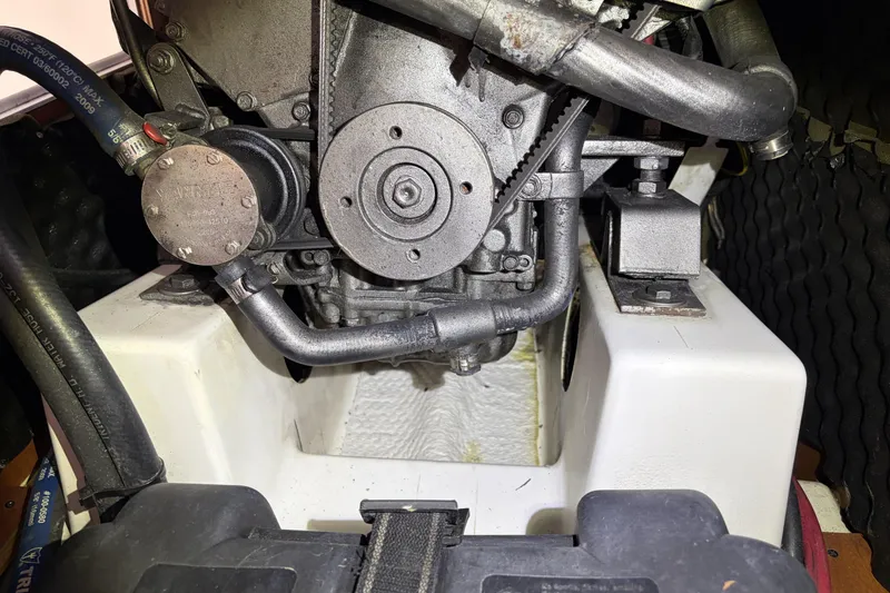 Slide: The Image of Engine compartment of a 2010 Beneteau Oceanis 37 sailboat, showcasing mechanical components. - 82