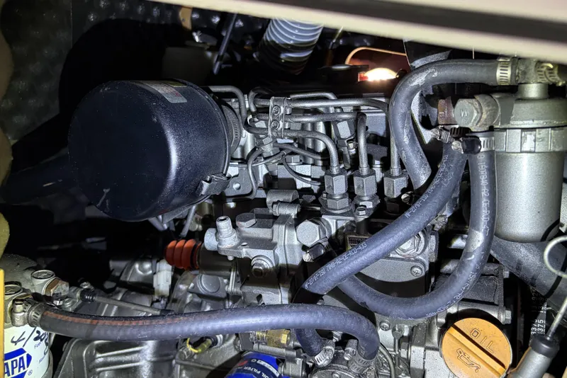 Slide: The Image of Engine compartment of a 2010 Beneteau Oceanis 37 sailboat, showcasing mechanical components. - 83