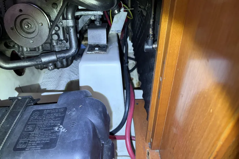 Slide: The Image of Engine compartment of a 2010 Beneteau Oceanis 37 sailboat, showing mechanical components and wiring. - 85