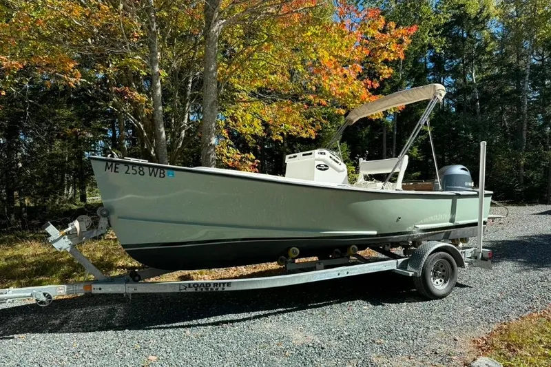 Slide: The Image of 2023 Seaway 18 Sportsman boat on trailer, surrounded by autumn trees. - 5