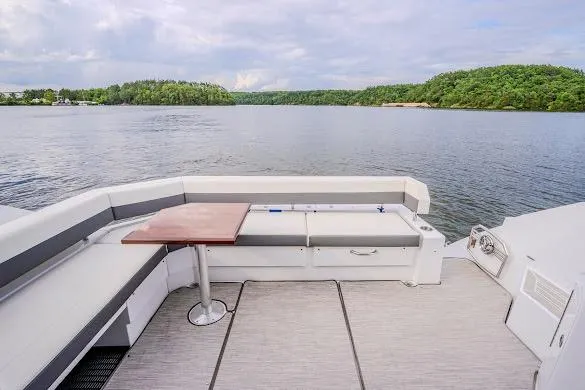 Slide: The Image of 2023 Cruisers Yachts 42 Cantius deck with seating, table, and scenic water view. - 39