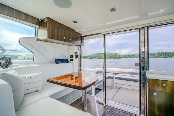 Slide: The Image of Luxurious interior of 2023 Cruisers Yachts 42 Cantius with lake view through large windows. - 41