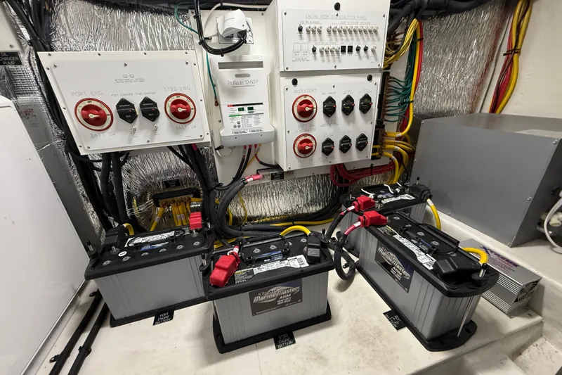 Slide: The Image of Electrical system and batteries in 2023 Cruisers Yachts 42 Cantius engine room. - 63