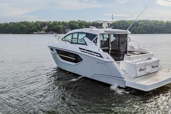 Slide: The Image of 2023 Cruisers Yachts 42 Cantius on serene lake, showcasing sleek design and modern features. - 7