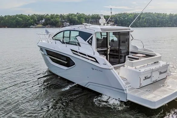 Slide: The Image of 2023 Cruisers Yachts 42 Cantius on serene lake, showcasing sleek design and luxury features. - 8