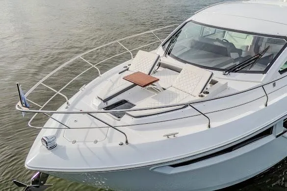 Slide: The Image of 2023 Cruisers Yachts 42 Cantius with sleek design and luxurious deck seating on calm water. - 9