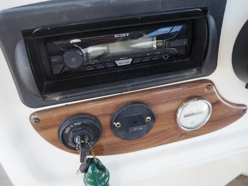 Slide: The Image of Dashboard of a Harris Sunliner 200 boat with Sony radio and ignition key. - 10