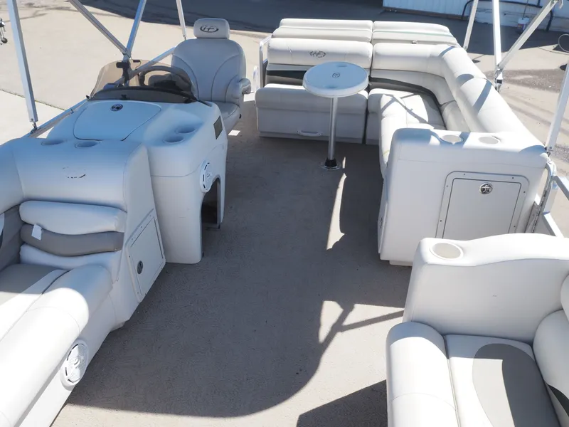 Slide: The Image of Interior of a 2005 Harris Sunliner 200 pontoon boat with white seating. - 11