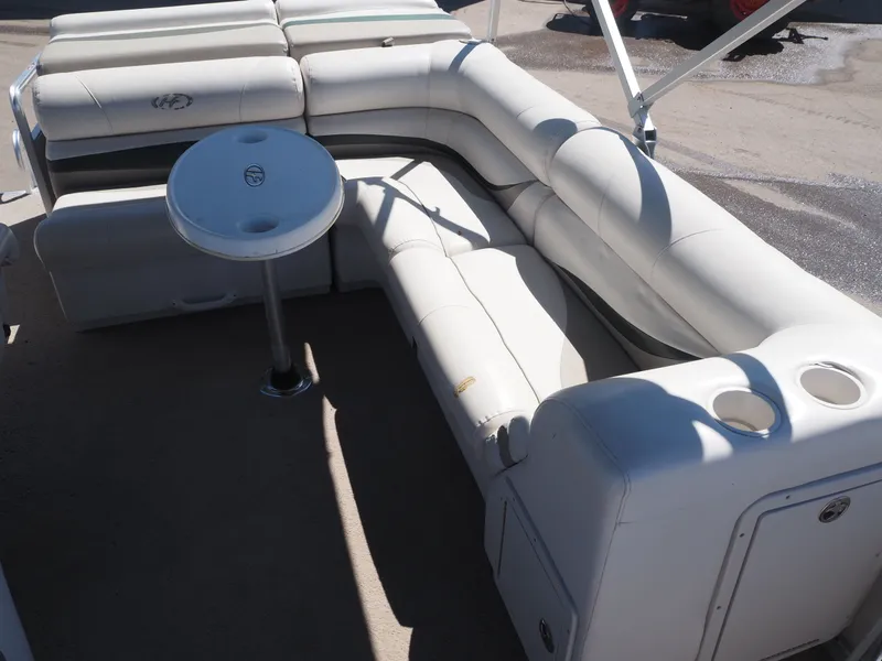 Slide: The Image of Interior of a 2005 Harris Sunliner 200 pontoon boat with white seating. - 14