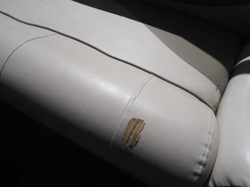 Slide: The Image of Damaged seat upholstery of a 2005 Harris Sunliner 200. - 15