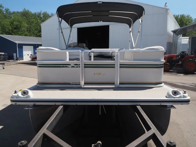 Slide: The Image of 2005 Harris Sunliner 200 pontoon boat in front of warehouse. - 3