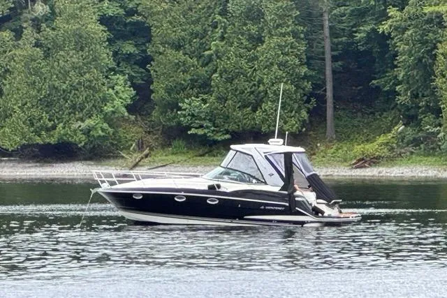 The Image of 2012 Monterey 340 Sport Yacht on a serene lake with lush green forest backdrop. - 0