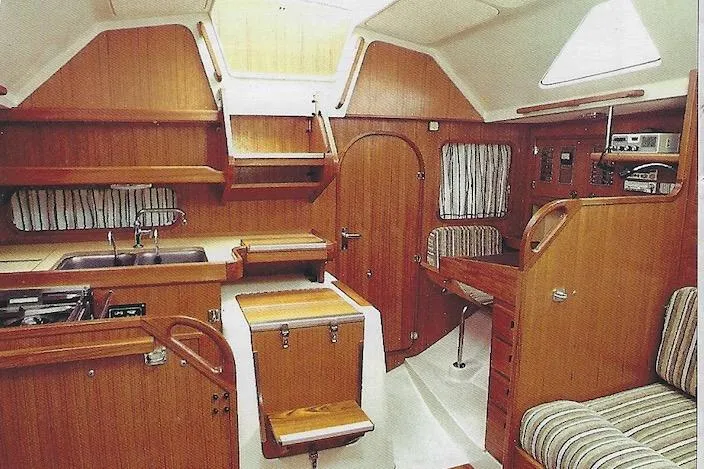Slide: The Image of Interior of a 1981 Yamaha 36 sailboat, featuring wood paneling and compact design. - 2