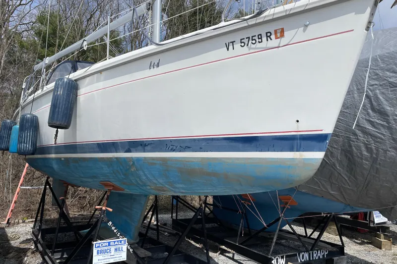 The Image of 1995 Hunter 336 sailboat on stands, for sale, with visible registration number. - 1
