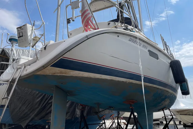 Slide: The Image of Hunter 336 sailboat from 1995 on dry dock, showing hull and keel. - 4