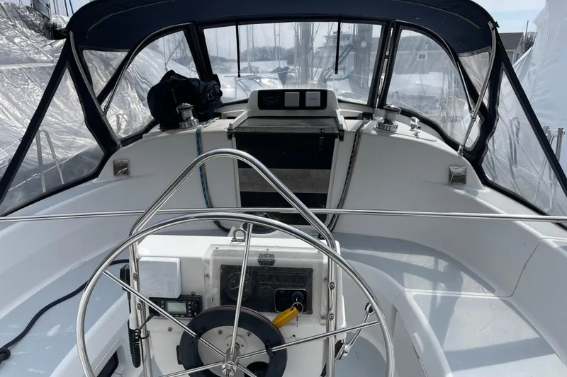 Slide: The Image of Cockpit of a 1995 Hunter 336 sailboat with steering wheel and navigation equipment. - 5