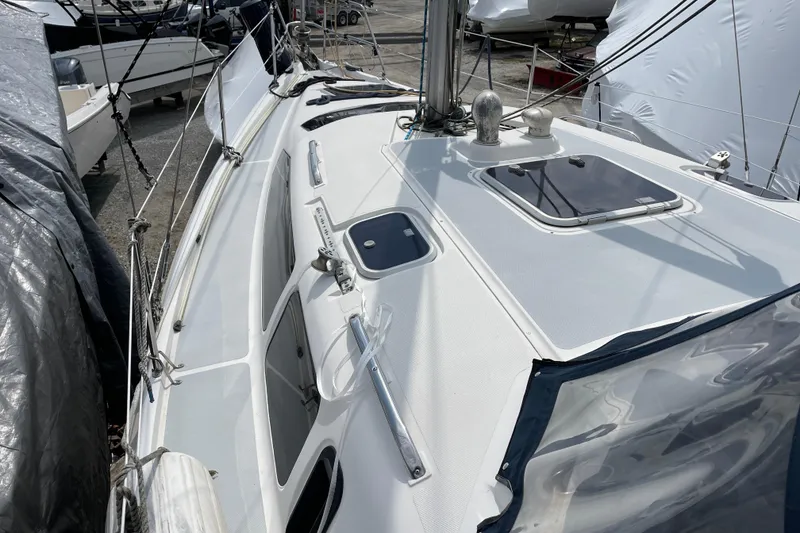 Slide: The Image of 1995 Hunter 336 sailboat deck with hatches and rigging, docked in a marina. - 6