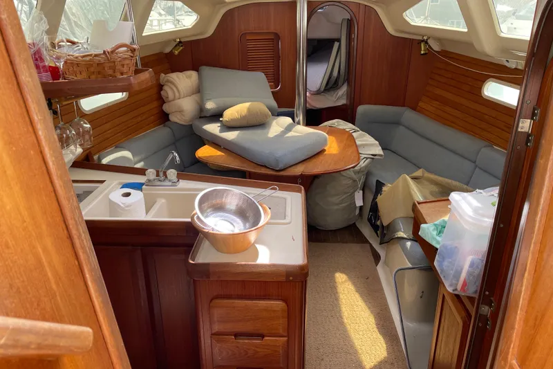 Slide: The Image of Interior of a 1995 Hunter 336 sailboat with cozy seating and kitchenette. - 8