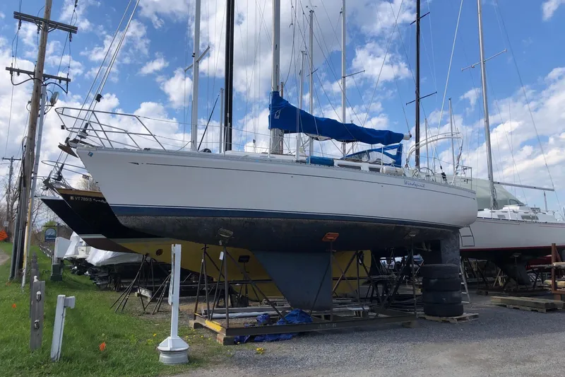 The Image of 1984 CAL 33 sailboat on dry dock with blue sky background. - 1
