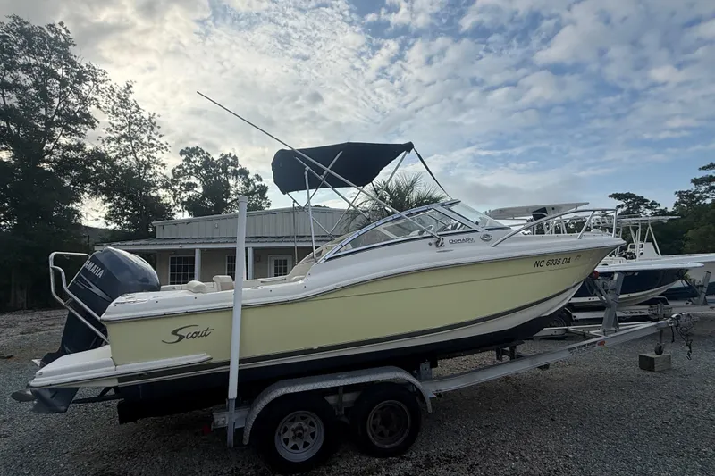Slide: The Image of 2005 Scout 222 Dorado boat on trailer with Yamaha engine, parked outdoors. - 2